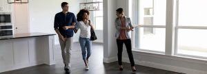 Real estate agent shows couple around a home