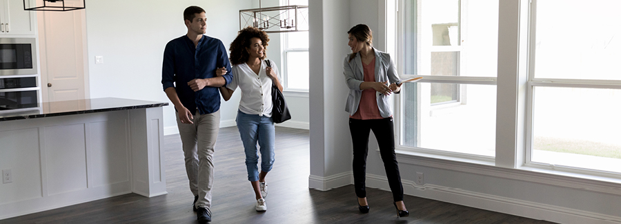 Real estate agent shows couple around a home