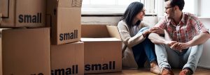 Couple sitting amongst boxes