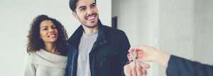 Couple smiling and receiving keys