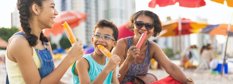 Woman and children eating popsicles