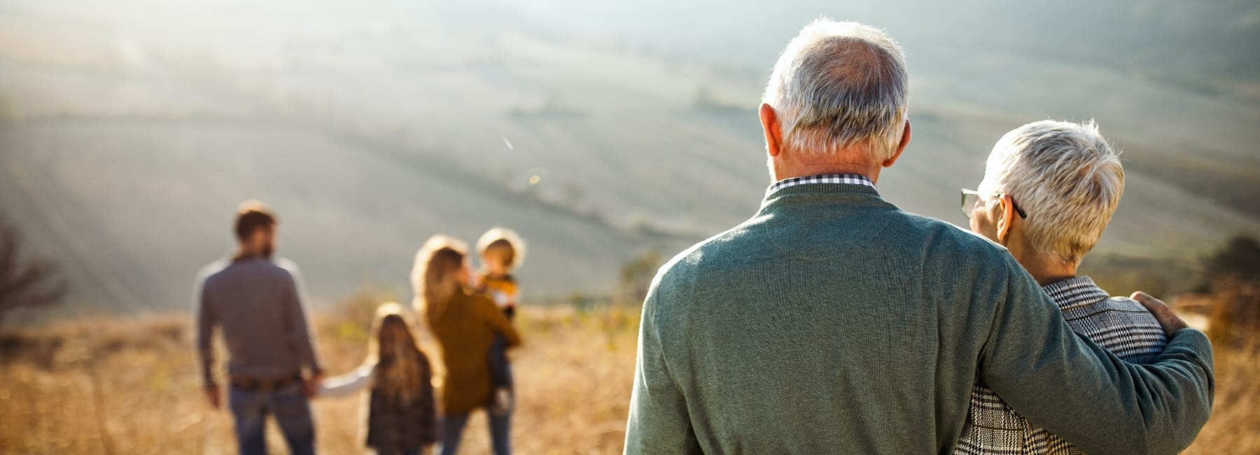 Elderly couple smiling at their grandchildren