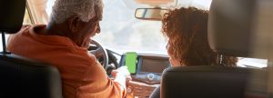 Older couple driving in their car