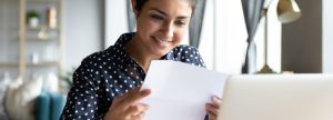 Woman smiling at a piece of paper
