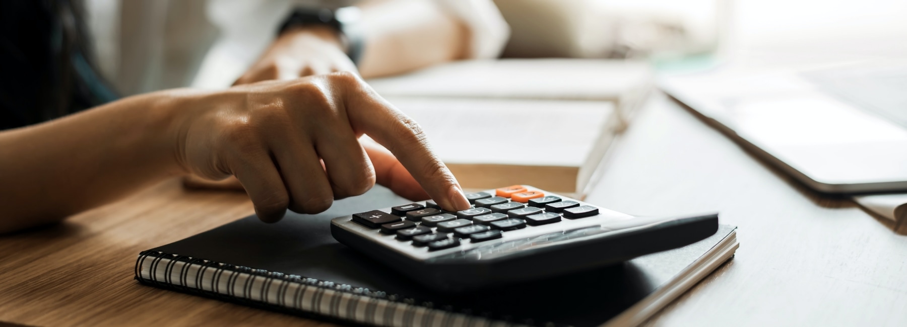 Woman typing on a calculator