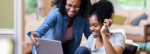 Mother and daughter looking at a laptop