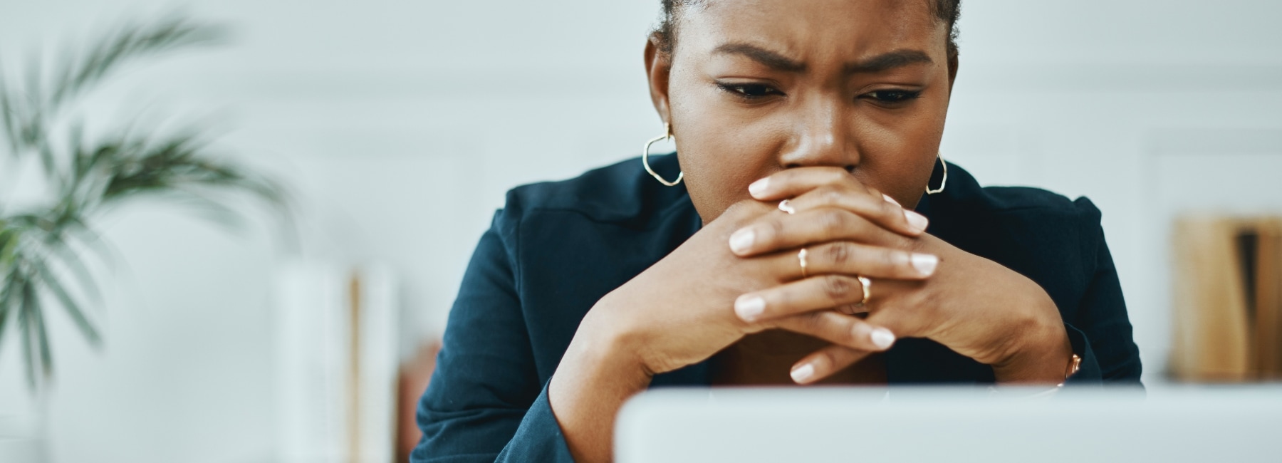 Woman upset looking at her laptop