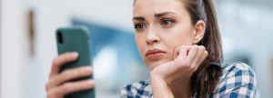 Woman upset looking at her phone