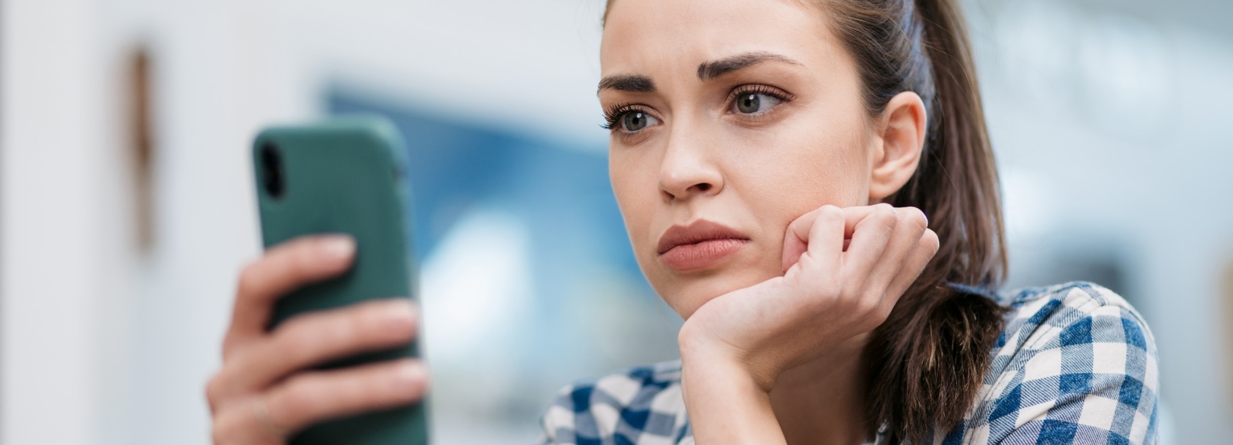 Woman upset looking at her phone