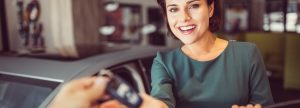 Woman being handed car keys