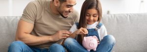 Father and daughter with a piggybank