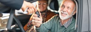 Older man receiving car keys