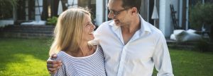 Couple standing outside their home