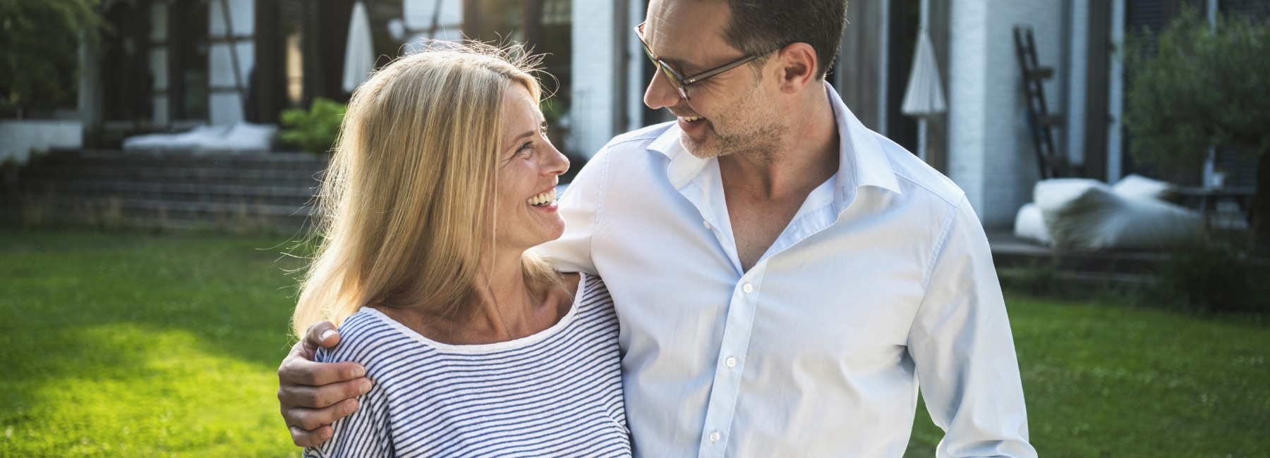 Couple standing outside their home