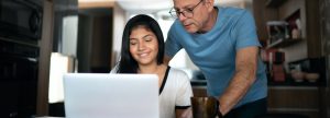 Father and daughter looking at a laptop