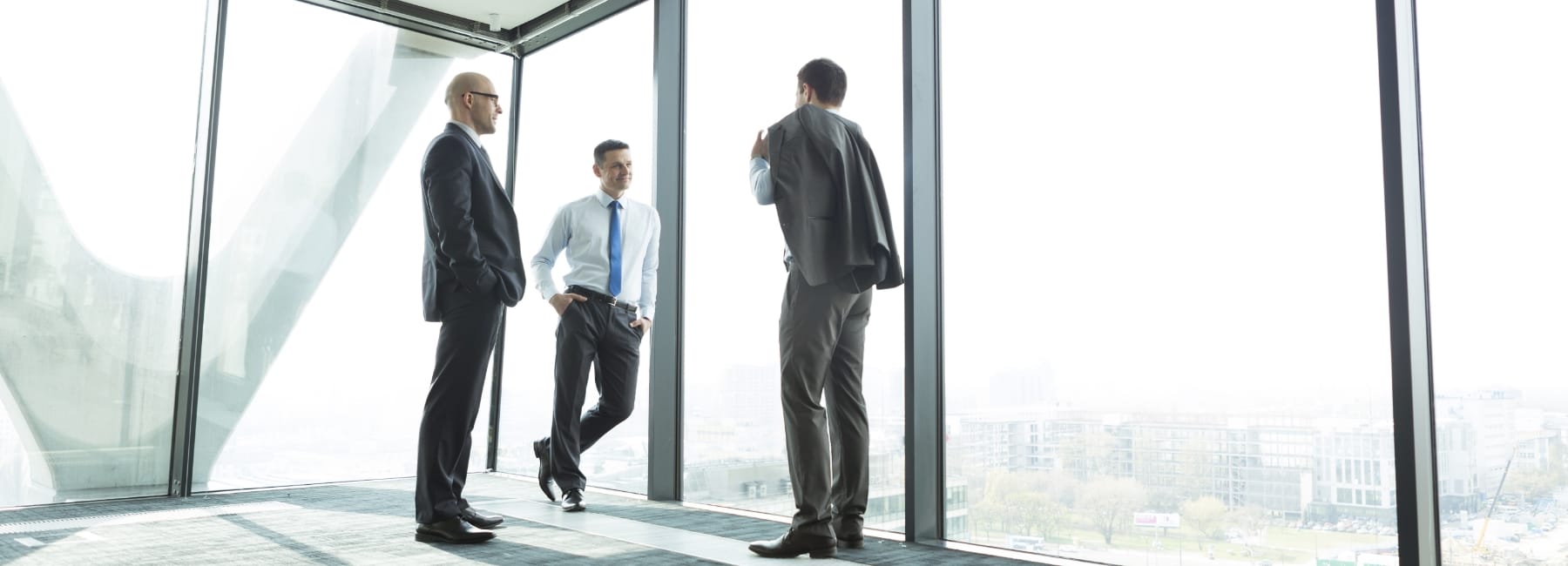 Men standing by a window