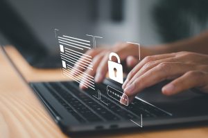 The image shows a person typing on a computer keyboard with a lock image, representing cyber security and data security.