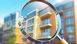 A magnifying glass focusing on the balconies and windows of a modern apartment building, with other blurred buildings in the background.