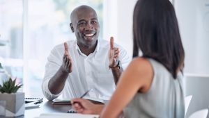 A man and woman converse at a table, illustrating a moment of connection and dialogue between them.